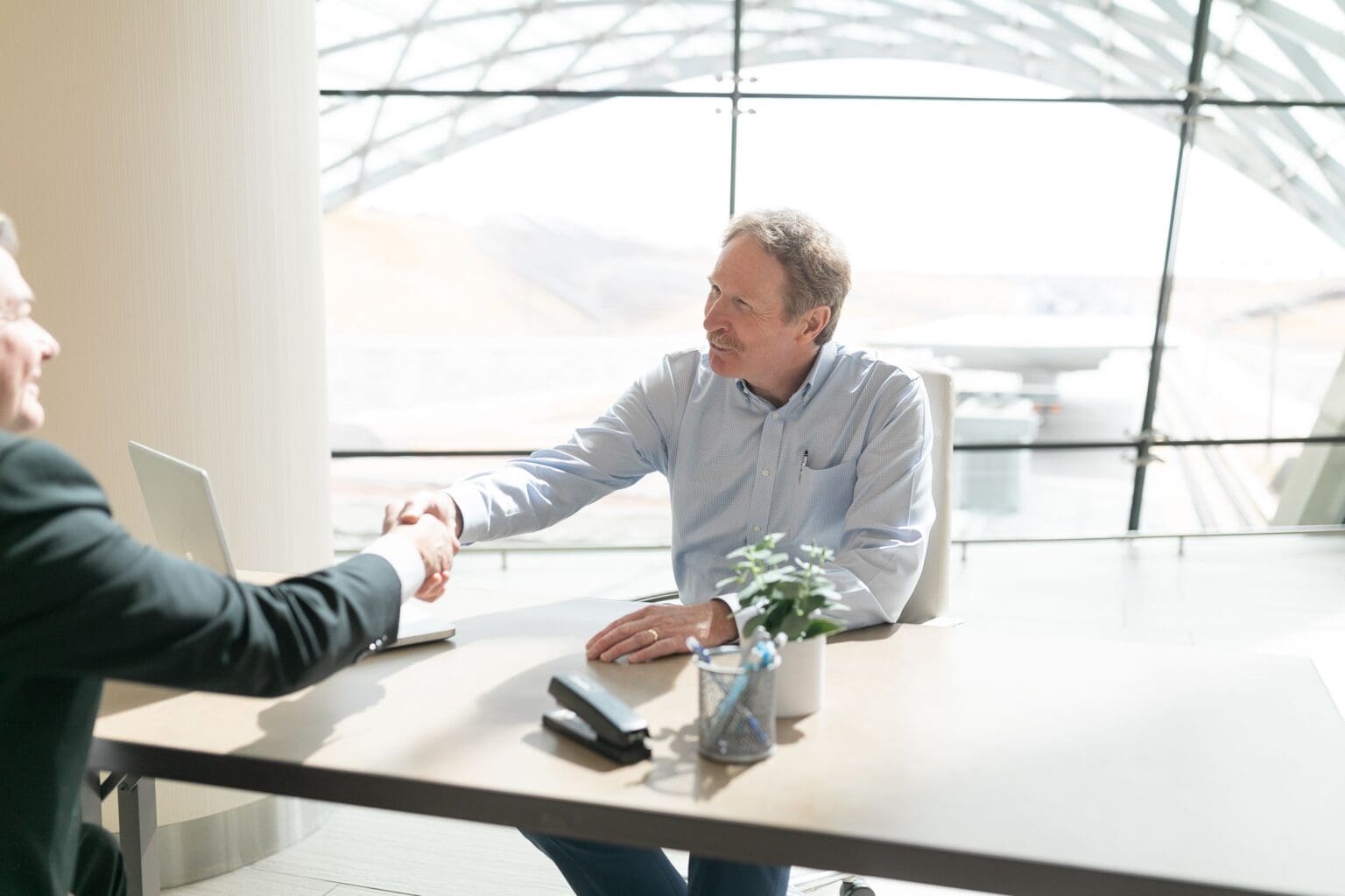 Dave Stanley greeting a visitor across the desk